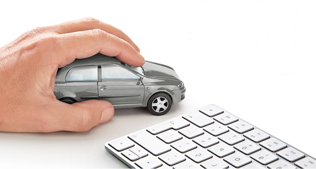 Hand moving car miniature near a keyboard